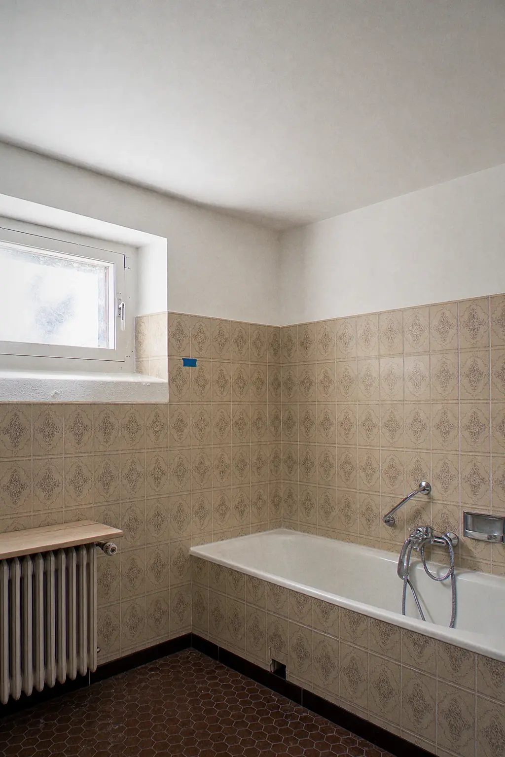 Bathroom after a full ceiling repair, original beige tiles kept